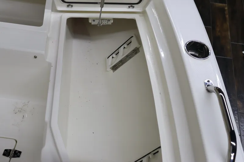 Slide: The Image of 2024 Pathfinder 2200 TRS boat storage compartment with open hatch. - 25