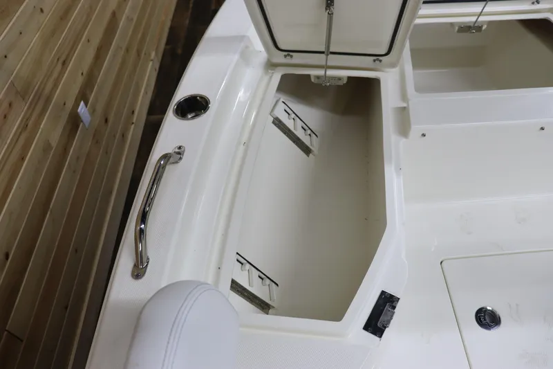 Slide: The Image of 2024 Pathfinder 2200 TRS boat storage compartment with open hatch and stainless steel handle. - 28