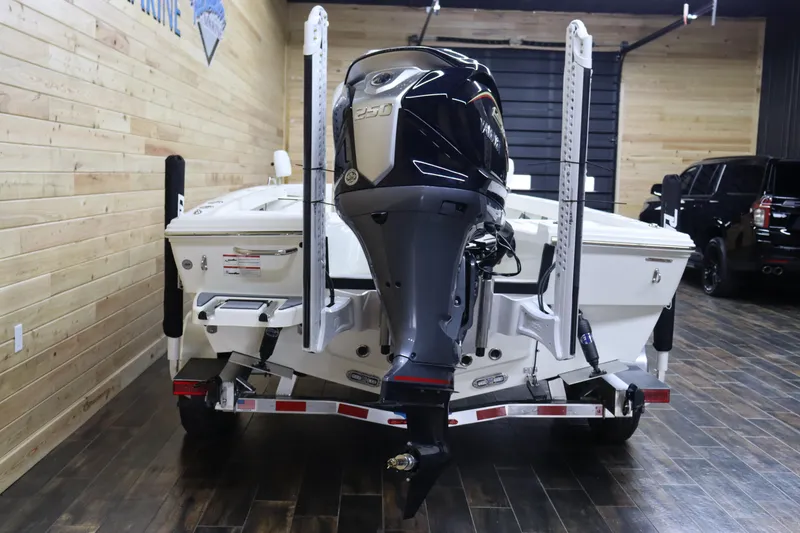 Slide: The Image of 2024 Pathfinder 2200 TRS boat with powerful outboard motor in showroom. - 4