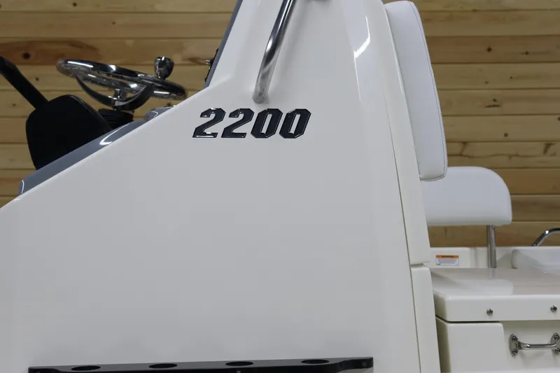 Slide: The Image of 2024 Pathfinder 2200 TRS boat console with steering wheel and seating. - 6