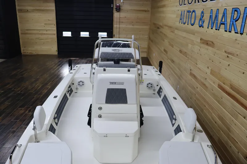 Slide: The Image of 2024 Pathfinder 2200 TRS boat interior in showroom with wooden walls. - 9