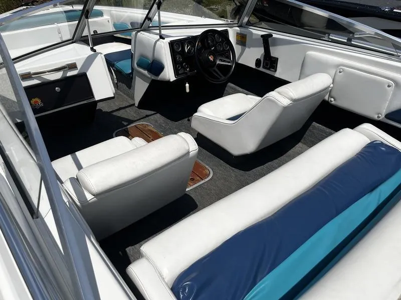 Slide: The Image of 1989 Baja SUNSPORT 174 boat interior with white and blue seating, steering wheel, and dashboard. - 3