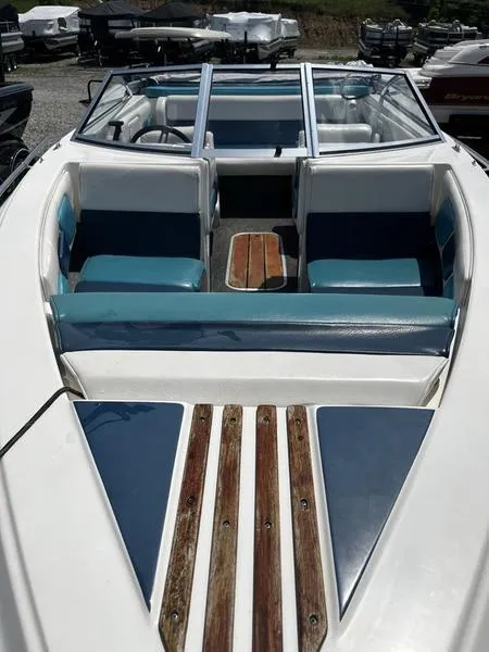 Slide: The Image of 1989 Baja SUNSPORT 174 boat with blue and white interior, wooden accents, and open seating. - 6