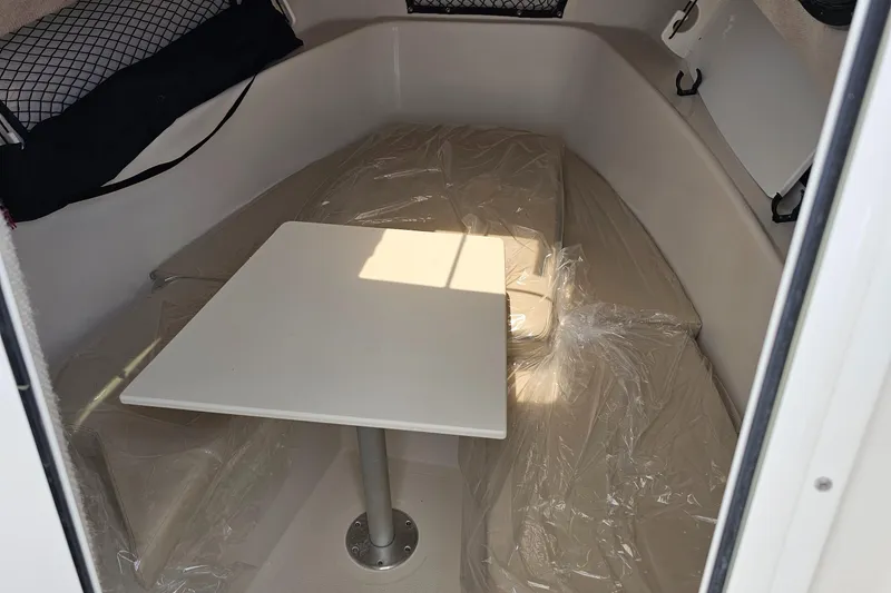 Slide: The Image of 2024 Sailfish 220 WAC cabin interior with table and seating. - 12