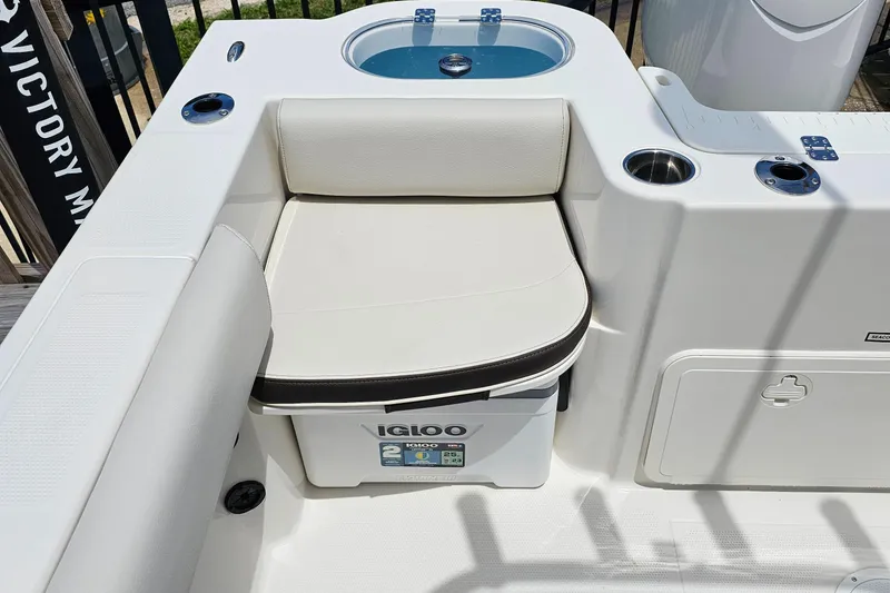 Slide: The Image of 2024 Sailfish 220 WAC boat seating area with Igloo cooler and livewell. - 6