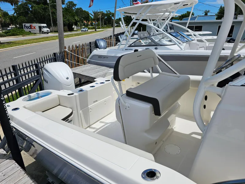 Slide: The Image of 2024 Sailfish 220 WAC boat interior with seating and outboard motor. - 7