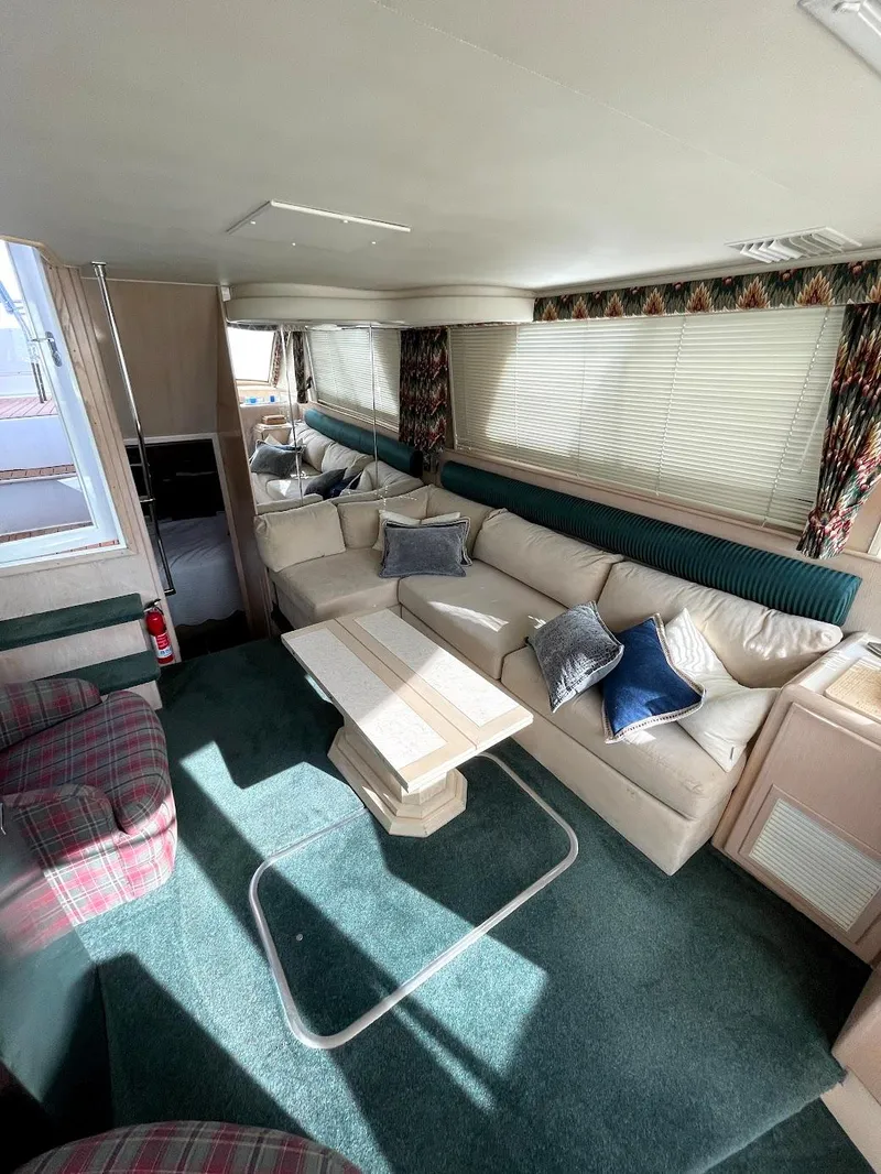 Slide: The Image of Interior of 1991 Hatteras 40 Motor Yacht with plush seating and elegant decor. - 12