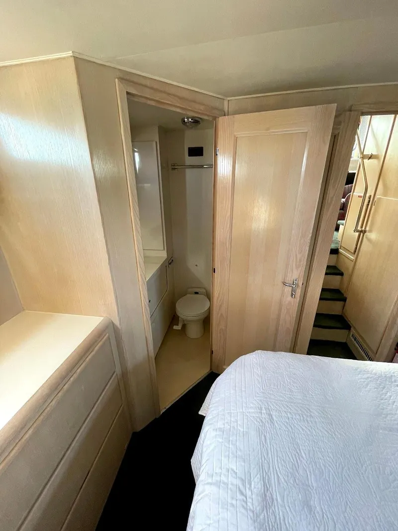 Slide: The Image of 1991 Hatteras 40 Motor Yacht interior with bedroom and bathroom view. - 15