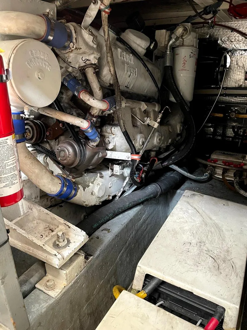 Slide: The Image of Engine room of a 1991 Hatteras 40 Motor Yacht, showcasing mechanical components and fire extinguisher. - 16
