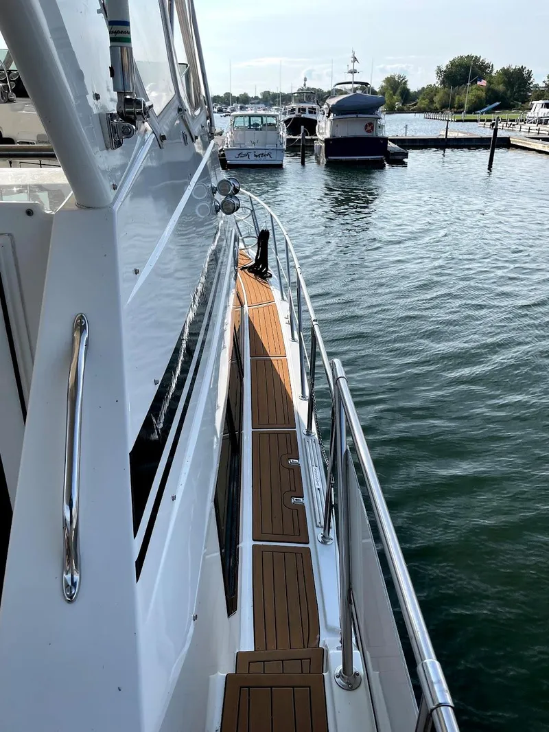Slide: The Image of 1991 Hatteras 40 Motor Yacht docked at a marina, side deck view. - 18