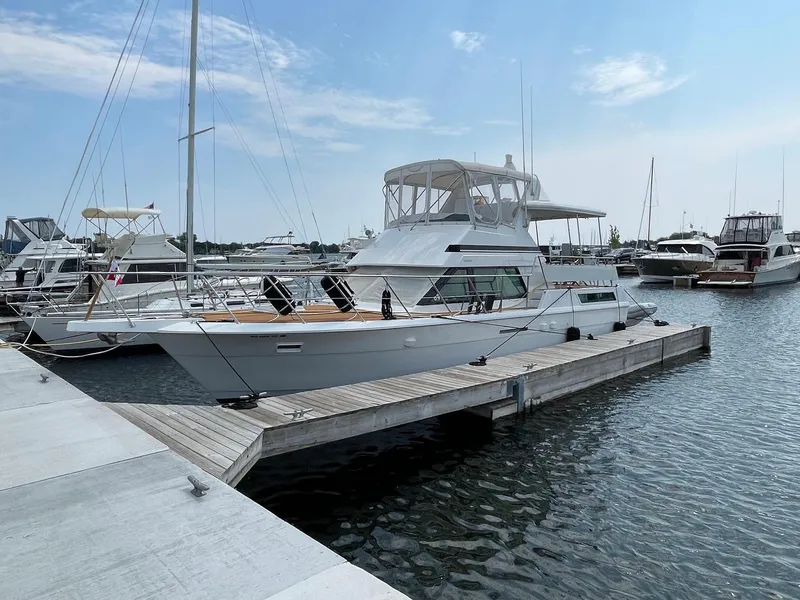 Slide: The Image of 1991 Hatteras 40 Motor Yacht docked at a marina under a clear blue sky. - 20