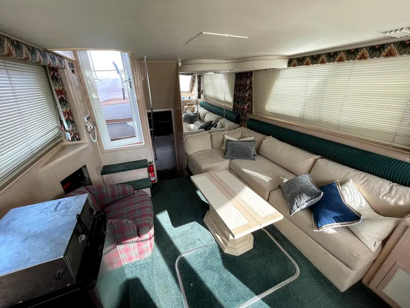 Slide: The Image of Interior of 1991 Hatteras 40 Motor Yacht with cozy seating and natural light. - 4
