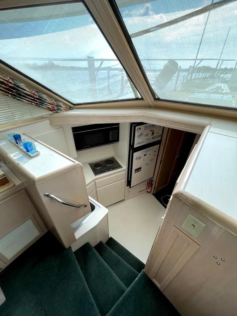 Slide: The Image of Interior view of 1991 Hatteras 40 Motor Yacht with stairs and kitchenette. - 5
