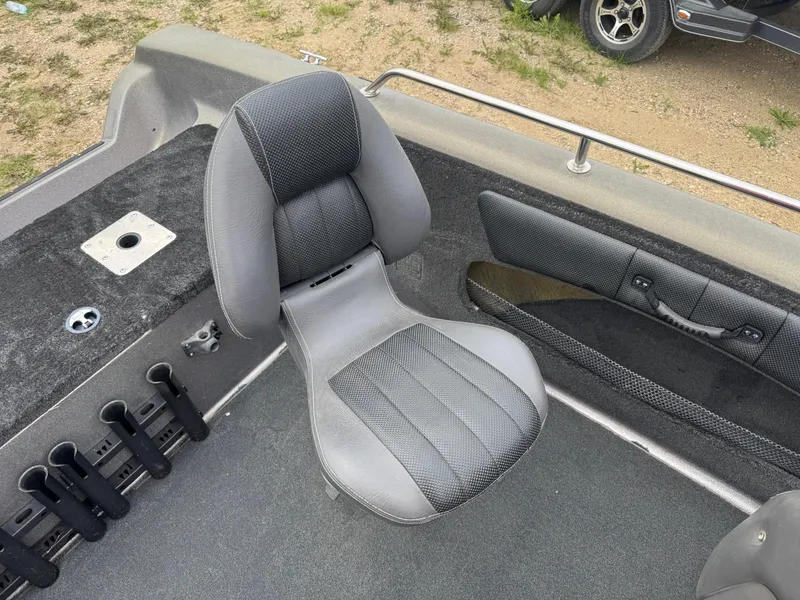 Slide: The Image of Boat interior with a gray seat, rod holders, and carpeted flooring, Stratos 385 XF, 2014 model. - 10