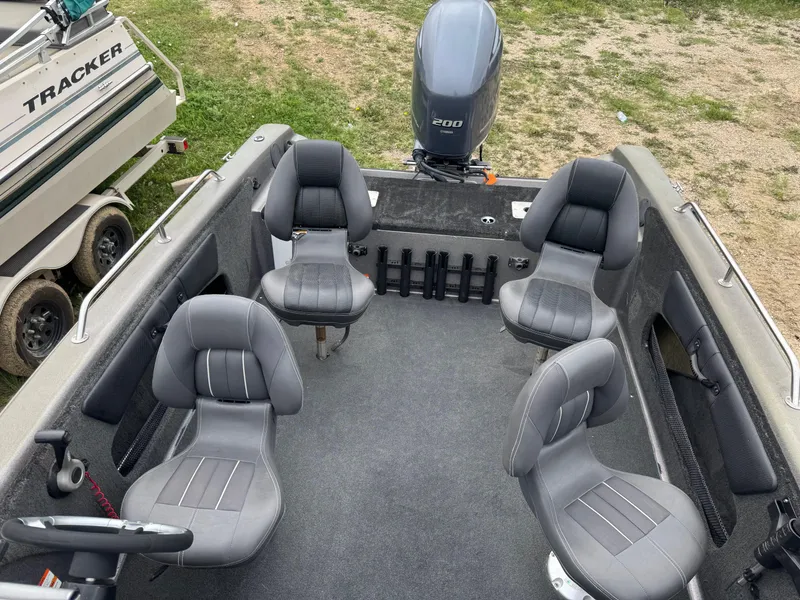 Slide: The Image of 2014 Stratos 385 XF boat interior with four seats and an outboard motor. - 12