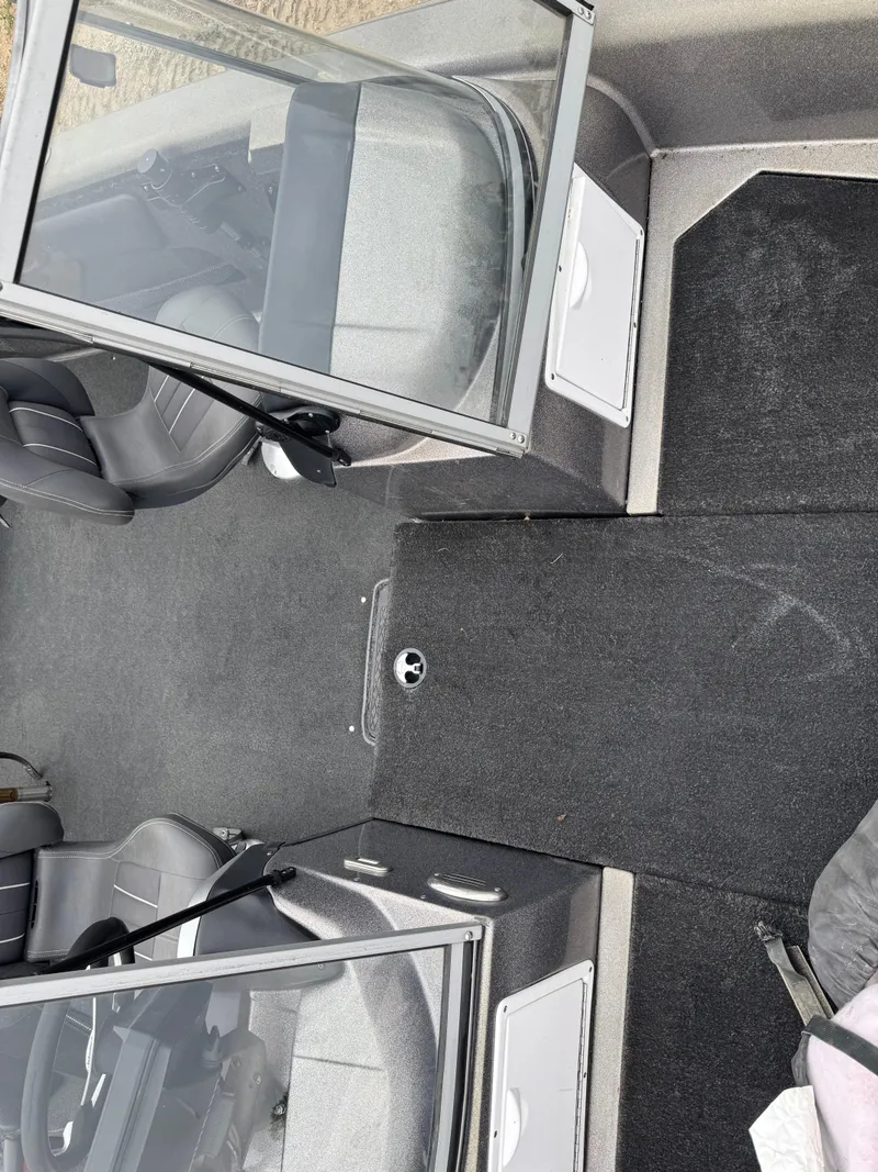 Slide: The Image of Interior of a 2014 Stratos 385 XF boat with open windshield and seating. - 14