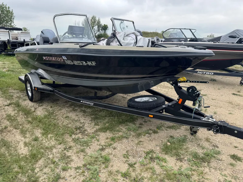 Slide: The Image of 2014 Stratos 385 XF boat on trailer, parked on grass. - 2