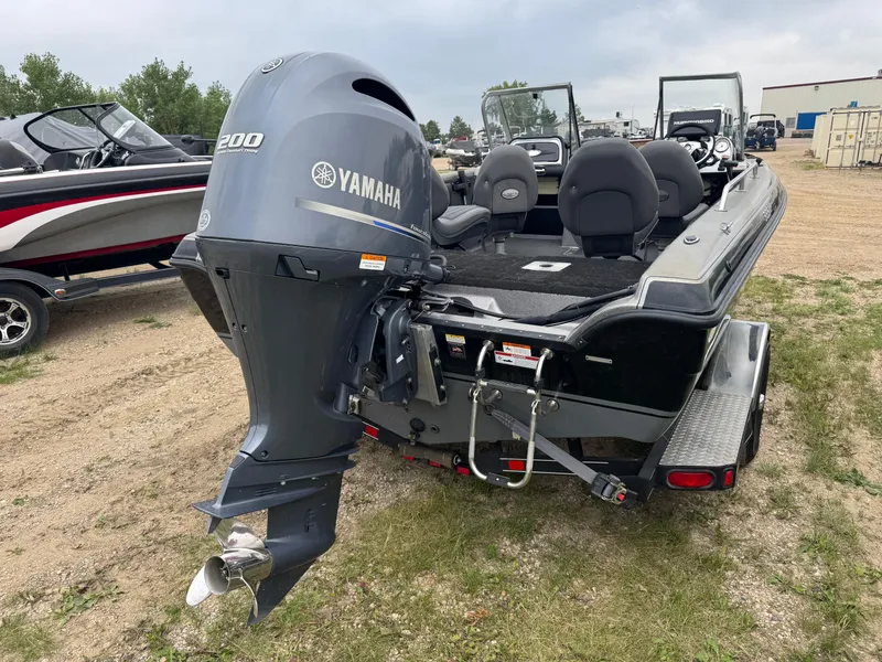Slide: The Image of 2014 Stratos 385 XF boat with Yamaha 200 engine, parked on grass. - 4