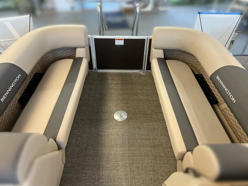 Slide: The Image of 2024 Bennington 22SSR boat interior with beige seating and carpeted floor. - 13