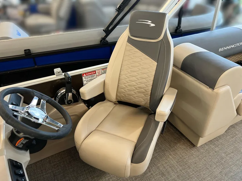 Slide: The Image of 2024 Bennington 22SSR boat interior with steering wheel and captain's chair. - 15