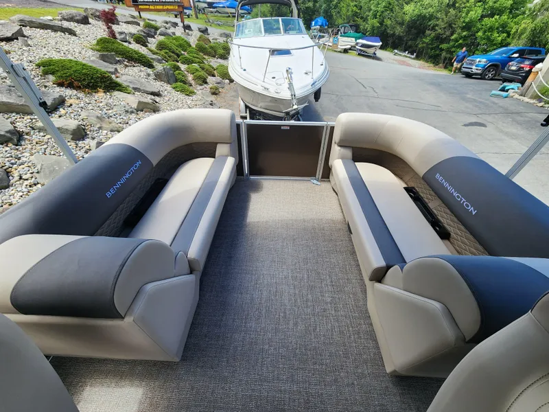 Slide: The Image of 2024 Bennington 22SSR pontoon boat interior with plush seating and modern design. - 4