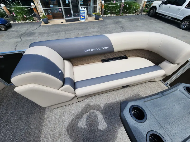 Slide: The Image of 2024 Bennington 22SSR pontoon boat with beige and gray seating. - 5
