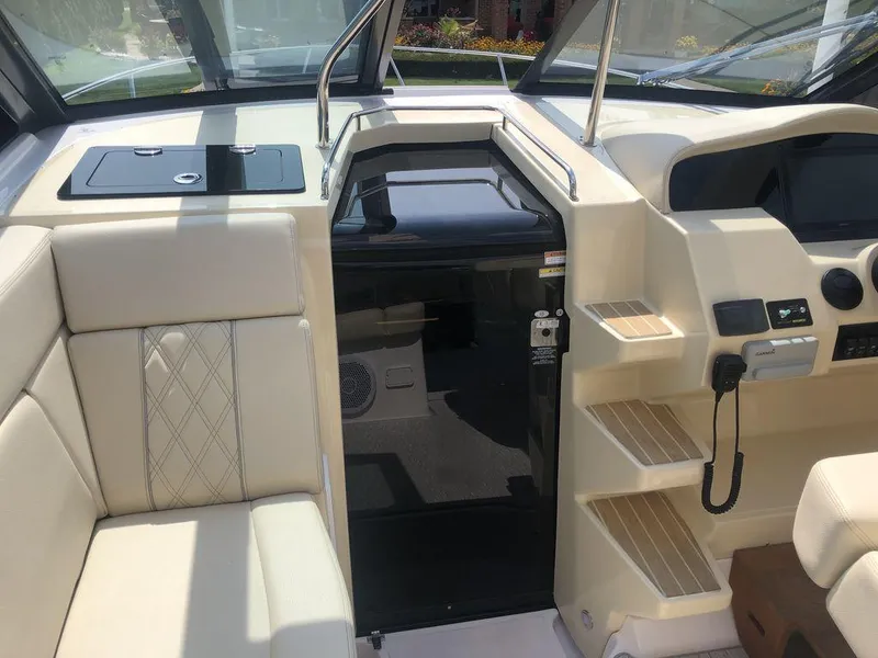 Slide: The Image of Interior of a 2020 Regal 35 Sport Coupe boat with seating and control panel. - 11