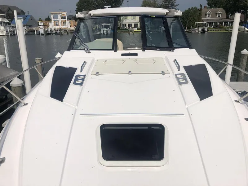Slide: The Image of 2020 Regal 35 Sport Coupe docked at a marina, front deck view. - 12