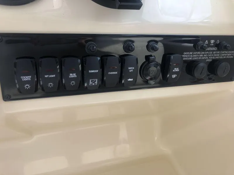Slide: The Image of Control panel of a 2020 Regal 35 Sport Coupe boat with various switches. - 15