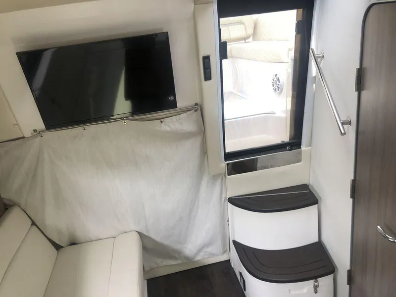 Slide: The Image of Interior of 2020 Regal 35 Sport Coupe with TV, stairs, and seating area. - 16