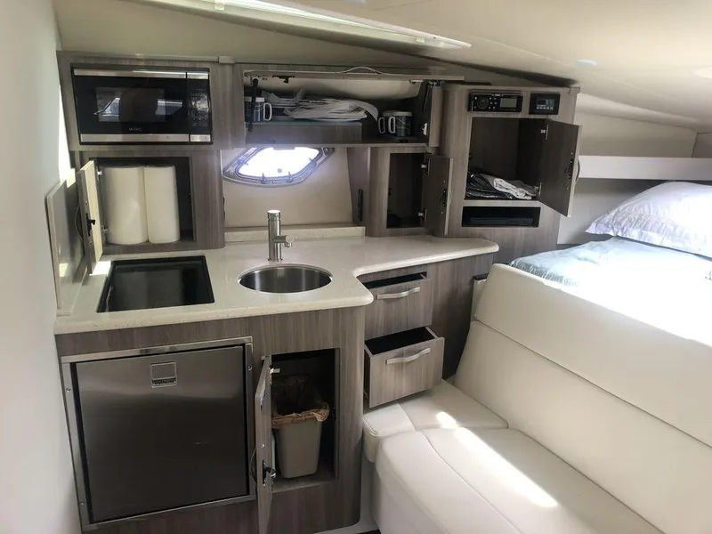 Slide: The Image of Interior of 2020 Regal 35 Sport Coupe with kitchenette and seating area. - 26