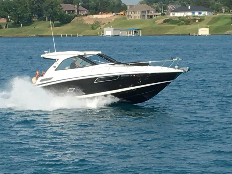 Slide: The Image of 2020 Regal 35 Sport Coupe cruising on a lake with waterfront homes in the background. - 3