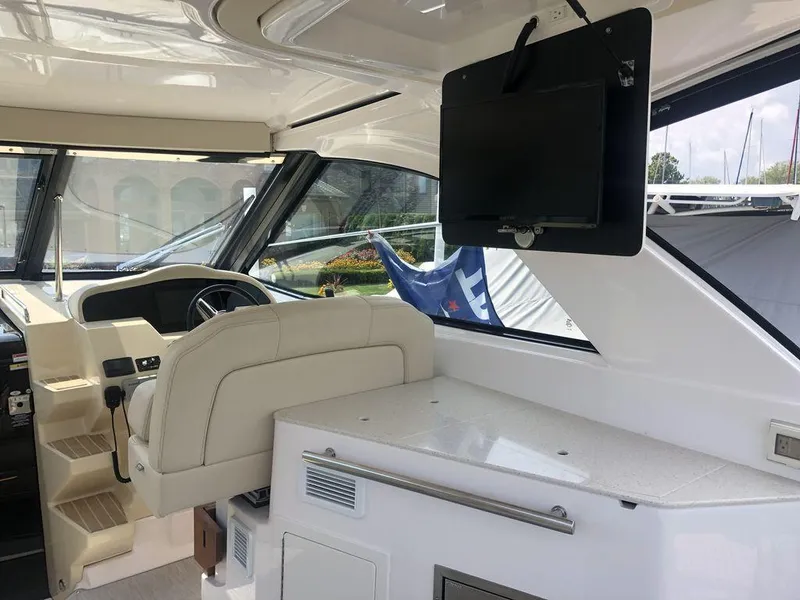 Slide: The Image of Interior helm of 2020 Regal 35 Sport Coupe with steering wheel and mounted TV. - 30
