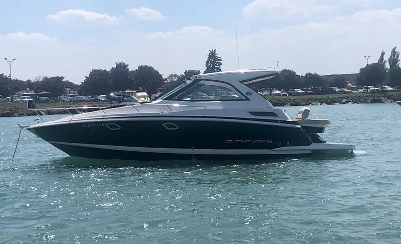 Slide: The Image of 2020 Regal 35 Sport Coupe yacht on water near shoreline. - 4