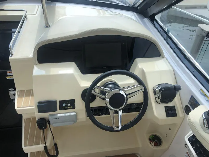 Slide: The Image of 2020 Regal 35 Sport Coupe helm with steering wheel, controls, and Garmin electronics. - 6