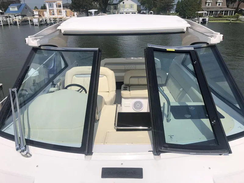 Slide: The Image of 2020 Regal 35 Sport Coupe boat interior with open sunroof and waterfront view. - 9