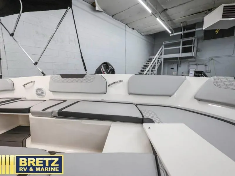 Slide: The Image of 2024 Element M15 boat interior with gray seating, displayed at Bretz RV & Marine showroom. - 10