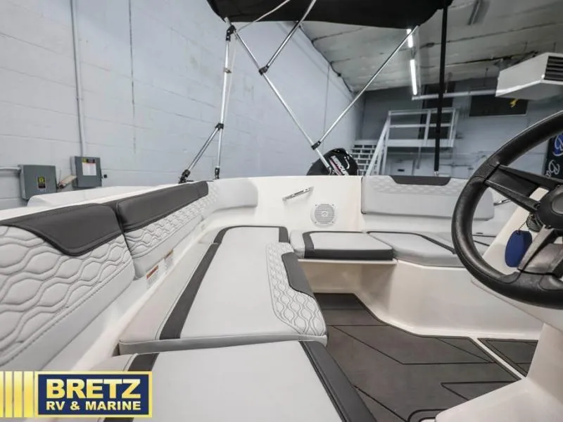 Slide: The Image of 2024 Element M15 boat interior with modern seating and steering wheel, showcased by Bretz RV & Marine. - 12