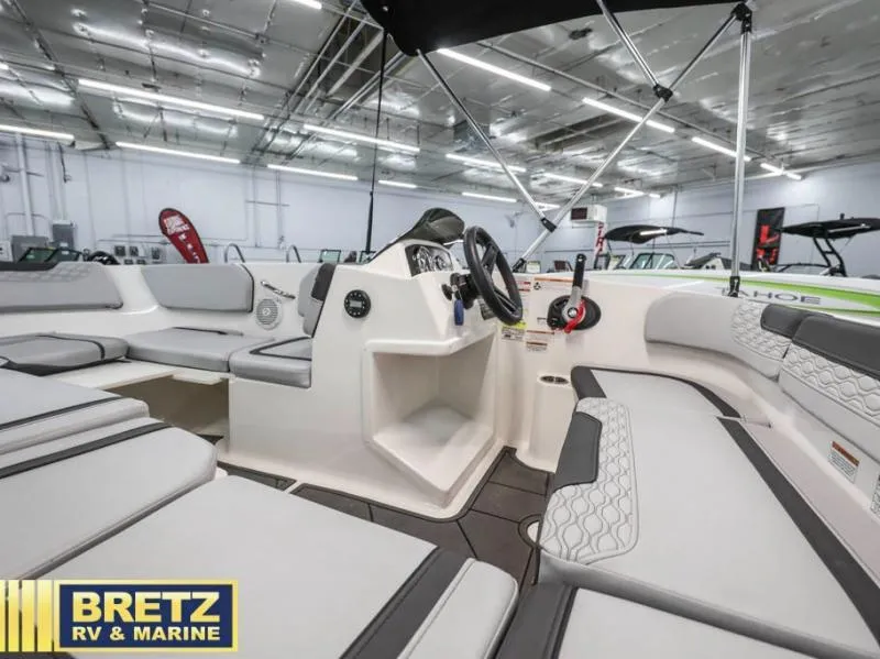 Slide: The Image of 2024 Element M15 boat interior with seating and steering console at Bretz RV & Marine showroom. - 16