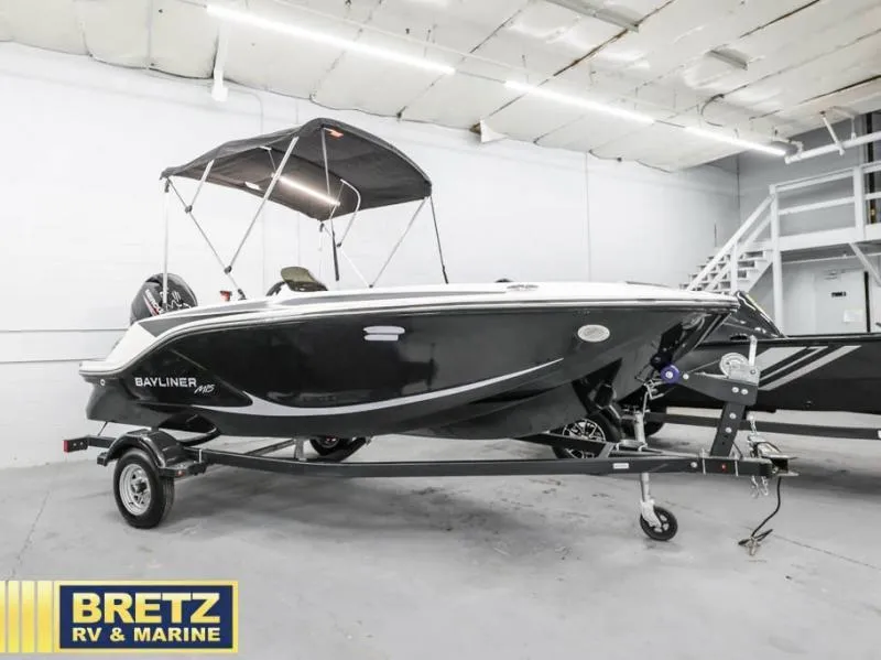 Slide: The Image of 2024 Element M15 boat on trailer in showroom, Bretz RV & Marine branding visible. - 5