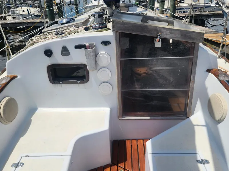 Slide: The Image of Cockpit of a 1985 Herreshoff 38 Cat Ketch sailboat with wooden flooring. - 10
