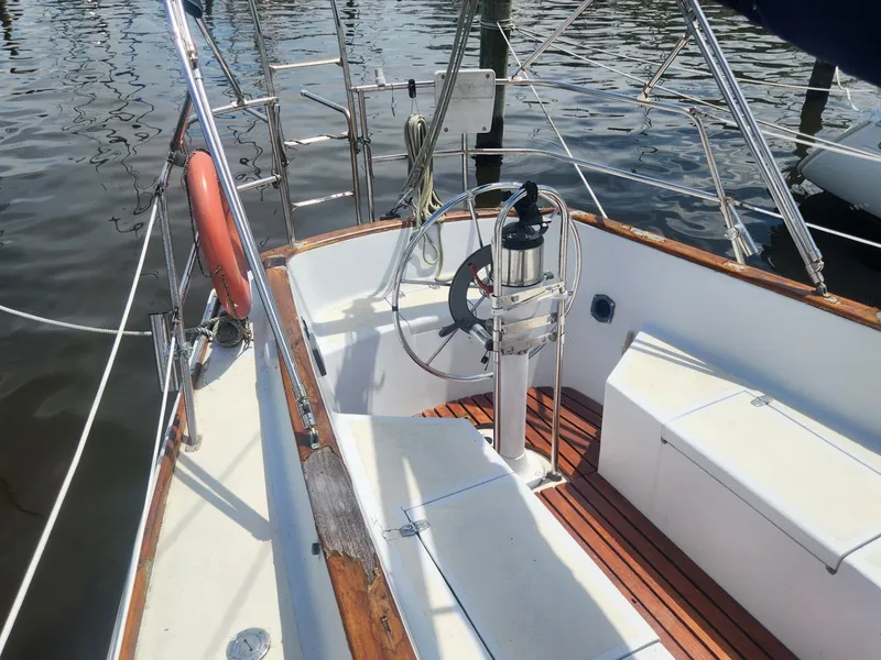 Slide: The Image of Cockpit of 1985 Herreshoff 38 Cat Ketch sailboat with wooden trim and steering wheel. - 11