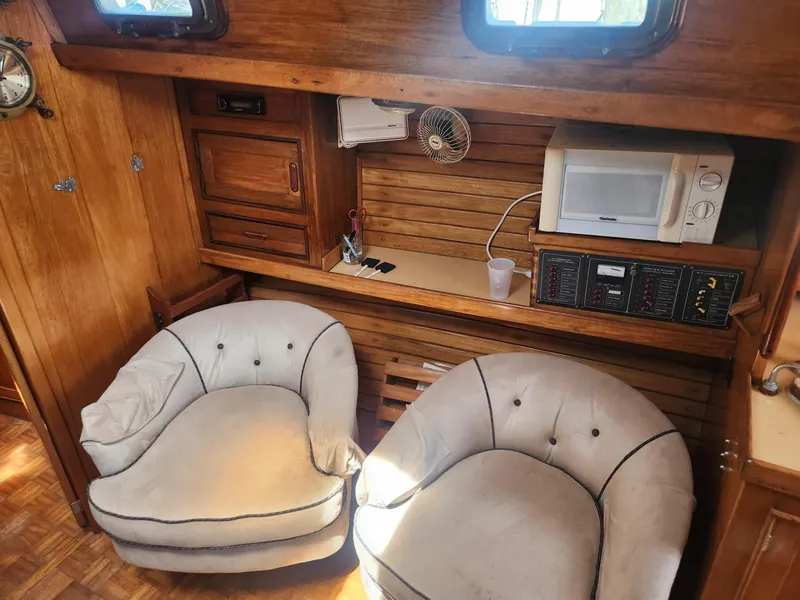 Slide: The Image of Interior of 1985 Herreshoff 38 Cat Ketch with cozy seating and microwave. - 22