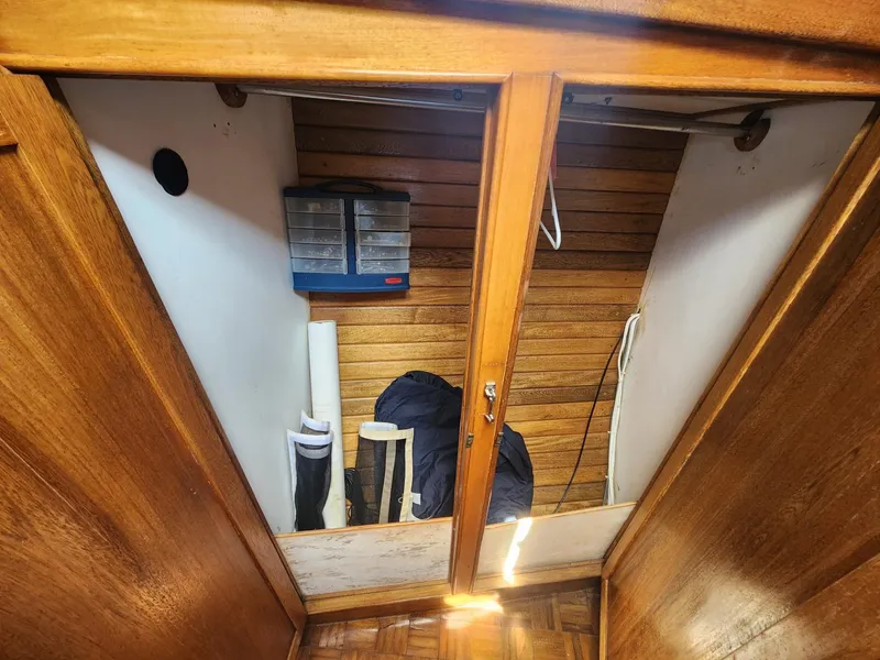 Slide: The Image of Interior storage space of 1985 Herreshoff 38 Cat Ketch sailboat with wooden finish. - 32