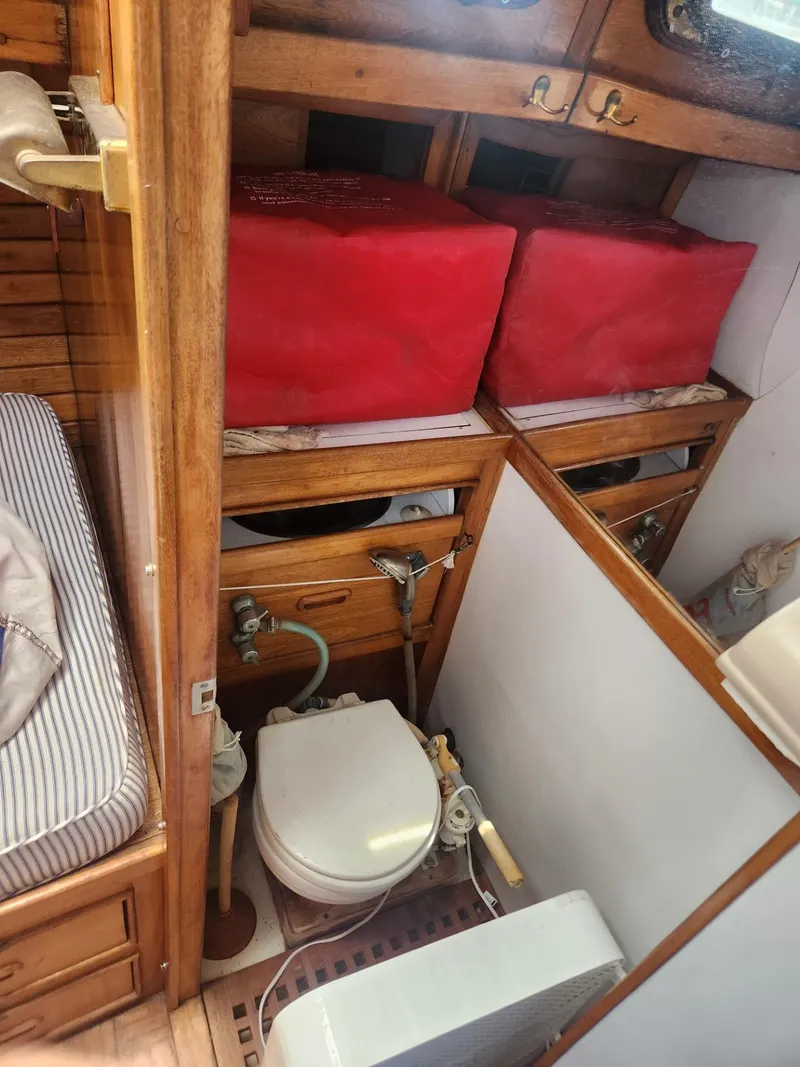Slide: The Image of 1985 Herreshoff 38 Cat Ketch boat interior with toilet and storage compartments. - 33