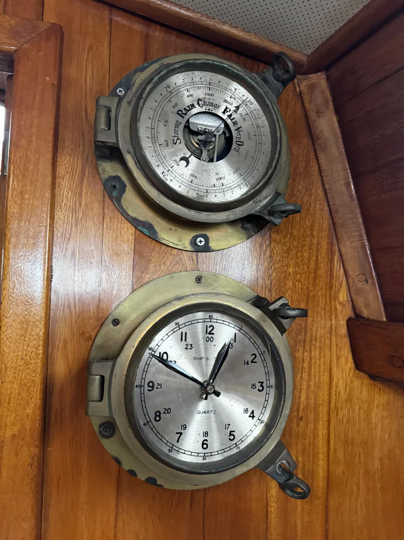 Slide: The Image of Vintage nautical barometer and clock on Herreshoff 38 Cat Ketch, 1985. - 38