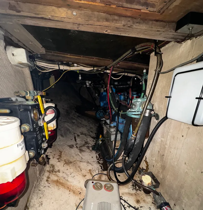 Slide: The Image of Engine room of 1985 Herreshoff 38 Cat Ketch with visible wiring and components. - 39