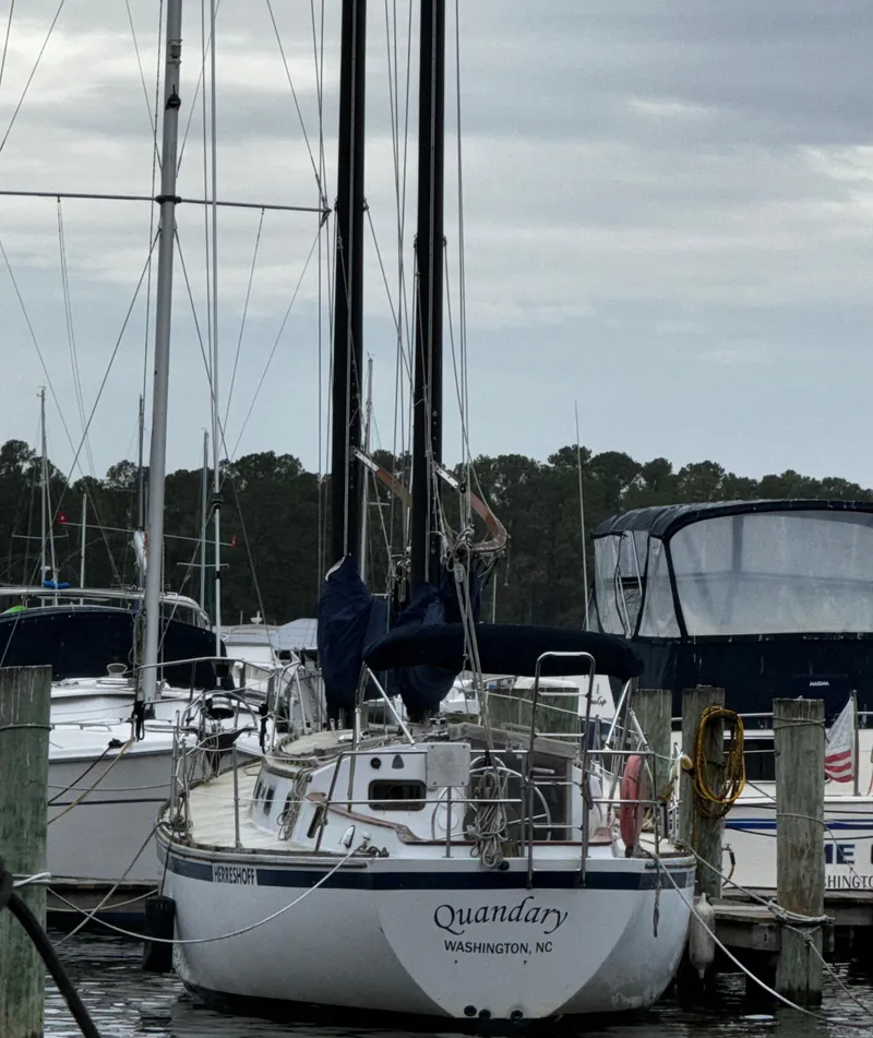 Slide: The Image of 1985 Herreshoff 38 Cat Ketch sailboat docked in marina, overcast sky. - 4