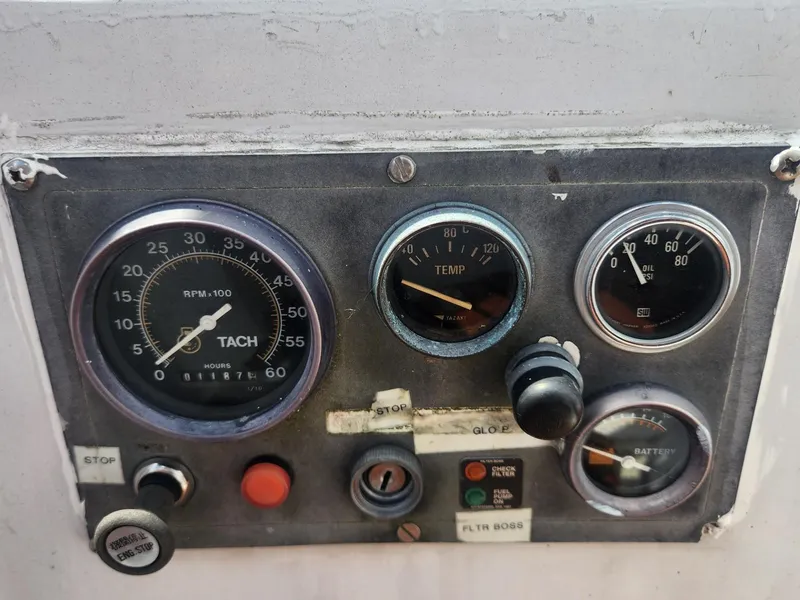 Slide: The Image of 1985 Herreshoff 38 Cat Ketch control panel with tachometer, temperature, oil, and battery gauges. - 42