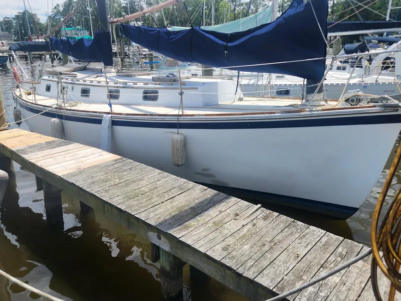 Slide: The Image of 1985 Herreshoff 38 Cat Ketch sailboat docked at a marina. - 7